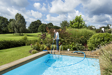 Image showing Man Cleaning Swimming Pool