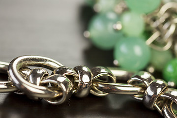 Image showing Green beads on an item of silver jewellery