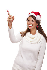 Image showing Young woman in a Santa hat holding out her hands