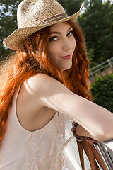 Image showing Gorgeous Woman in Hat on Cloudy Sky background