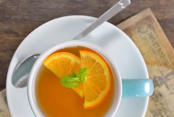 Image showing cup of tea and orange slices