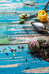 Image showing Tea leaves for brewing,tea spoon and dried yellow rose