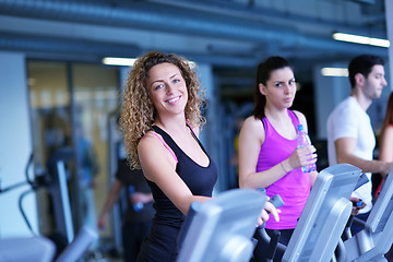 Image showing Group of people running on treadmills