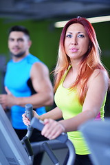 Image showing Group of people running on treadmills