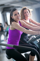 Image showing Group of people running on treadmills