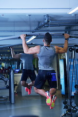 Image showing handsome man exercising at the gym