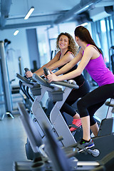 Image showing Group of people running on treadmills