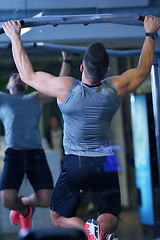 Image showing handsome man exercising at the gym