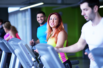 Image showing Group of people running on treadmills