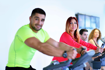 Image showing Group of people running on treadmills