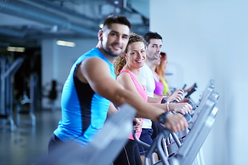 Image showing Group of people running on treadmills