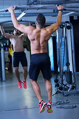 Image showing handsome man exercising at the gym