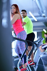 Image showing Group of people running on treadmills