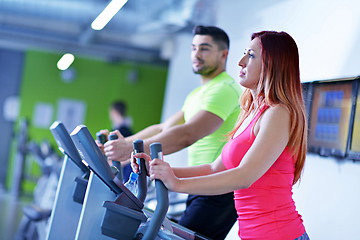 Image showing Group of people running on treadmills