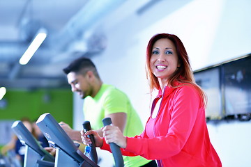 Image showing Group of people running on treadmills