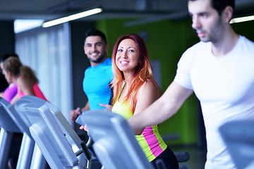 Image showing Group of people running on treadmills