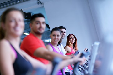 Image showing Group of people running on treadmills