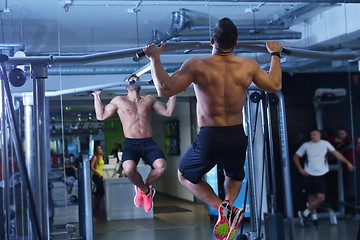 Image showing handsome man exercising at the gym