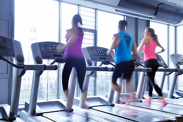 Image showing Group of people running on treadmills