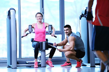 Image showing woman exercising with her personal trainer