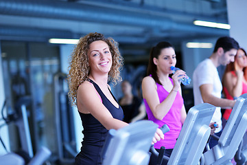 Image showing Group of people running on treadmills