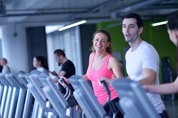 Image showing Group of people running on treadmills