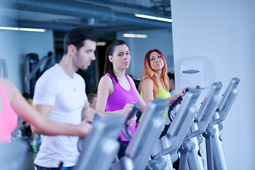 Image showing Group of people running on treadmills