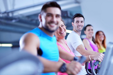 Image showing Group of people running on treadmills