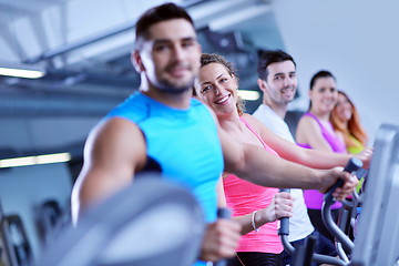 Image showing Group of people running on treadmills