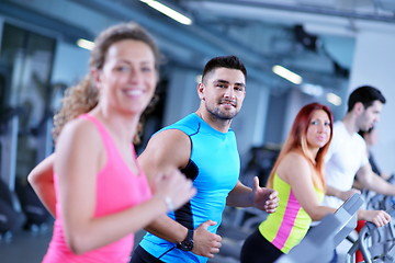 Image showing Group of people running on treadmills