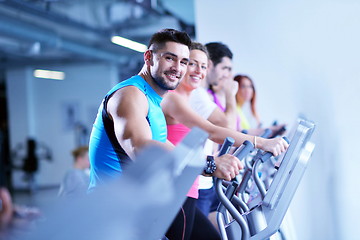 Image showing Group of people running on treadmills