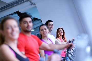 Image showing Group of people running on treadmills