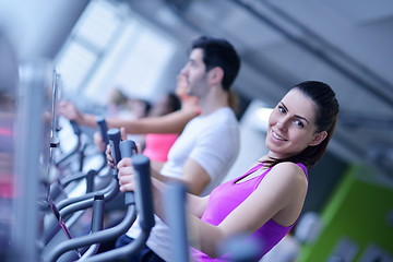 Image showing Group of people running on treadmills