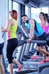 Image showing Group of people running on treadmills