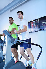 Image showing Group of people running on treadmills