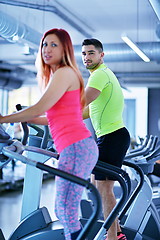 Image showing Group of people running on treadmills