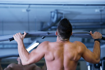 Image showing handsome man exercising at the gym