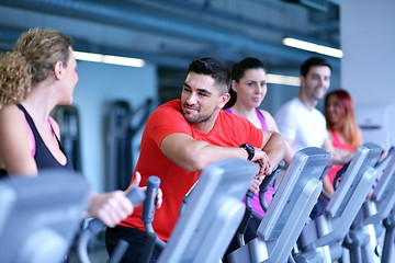 Image showing Group of people running on treadmills