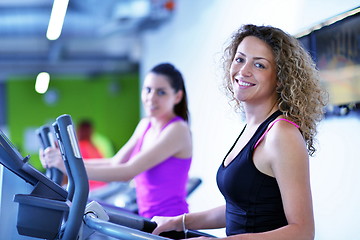 Image showing Group of people running on treadmills