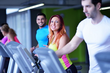 Image showing Group of people running on treadmills