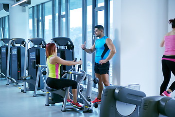 Image showing woman exercising with her personal trainer