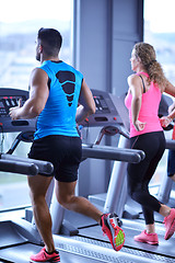 Image showing Group of people running on treadmills