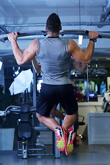 Image showing handsome man exercising at the gym