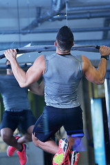 Image showing handsome man exercising at the gym