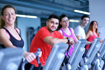 Image showing Group of people running on treadmills