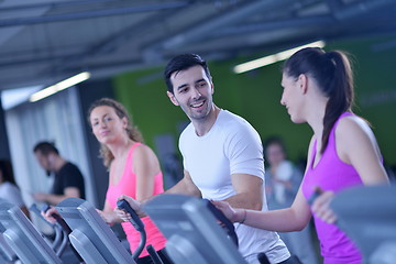 Image showing Group of people running on treadmills