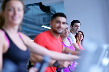 Image showing Group of people running on treadmills