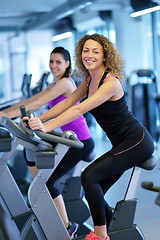 Image showing Group of people running on treadmills