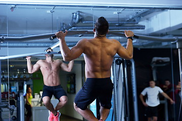 Image showing handsome man exercising at the gym