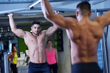 Image showing handsome man exercising at the gym